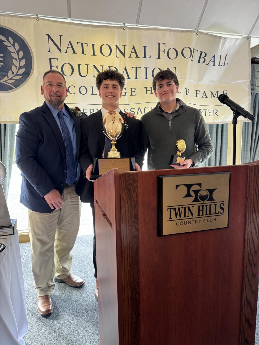 Coach Chad Labonte and students, Brendan Riberdy and Johnny Gingeruha receiveing football and academic awards at the Twin Hills Country Club in Longmeadow.