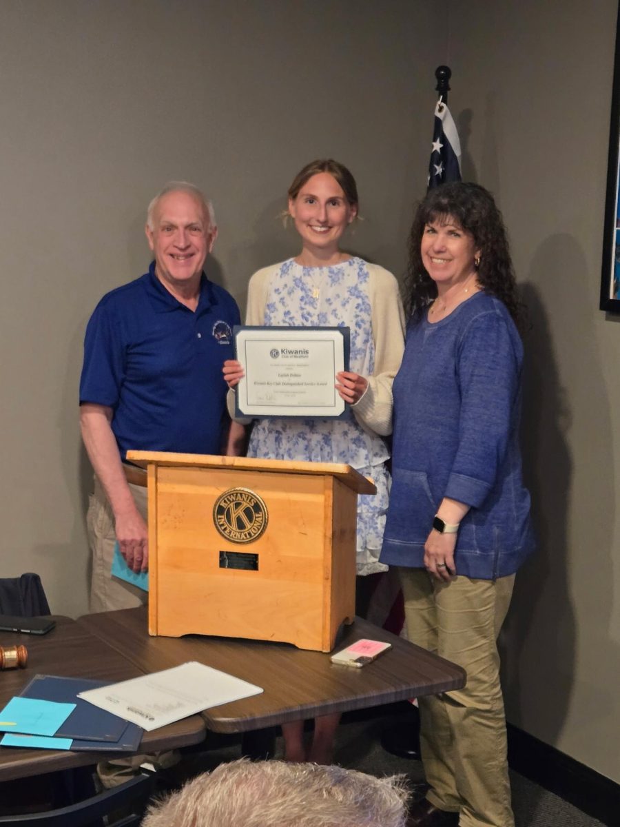 Laylah Debian receiving an award from the Kiwanis International Club alongside George Delisle and Anita-Ann Moore. 